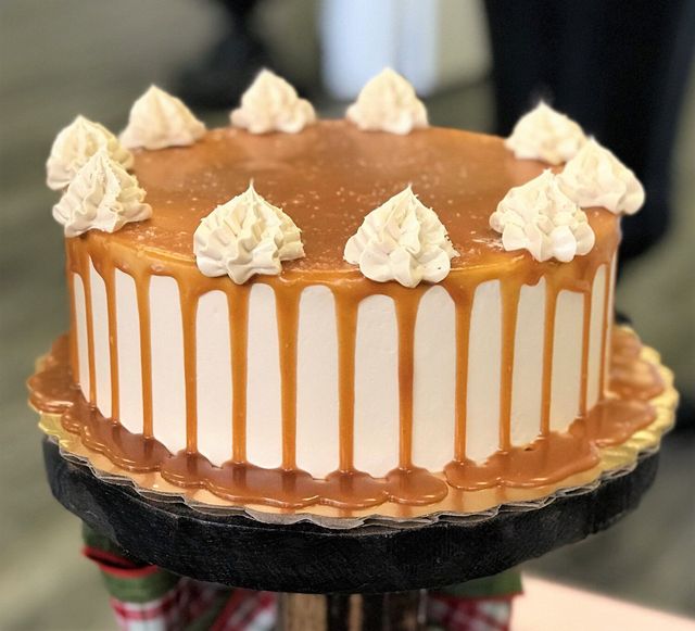 Caramel layer cake dripping with rich caramel glaze
