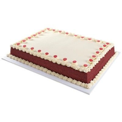 Red velvet sheet cake sliced into squares with cream cheese frosting, perfect for a crowd
